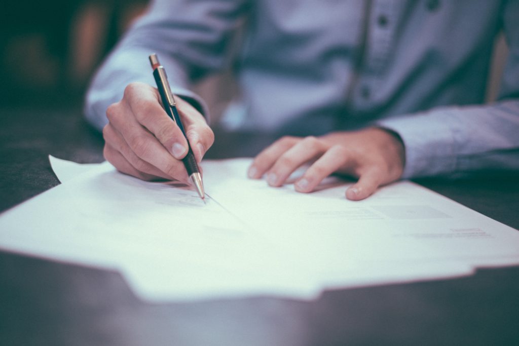 A person is reviewing paperwork