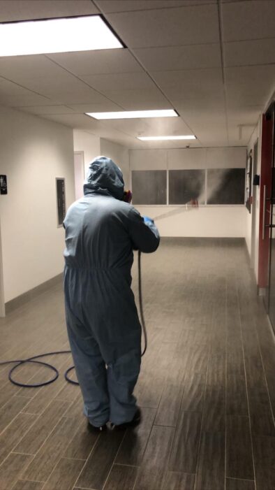 A worker spraying disinfection solution.