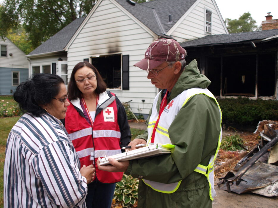 Red Cross Volunteers helping a house fire victim